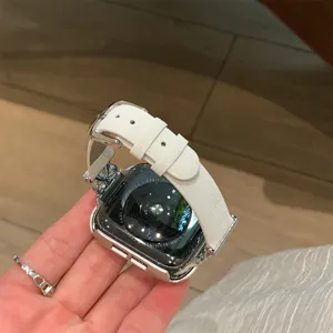 Detailed view of white leather watch band with bow attachment compatible with smart watch.