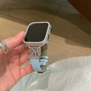 Close-up detail view of the elegant rhinestone Apple Watch case and light blue leather strap.