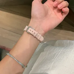 Pink leather watch strap detail view, compatible with smartwatches, featuring a silver buckle.