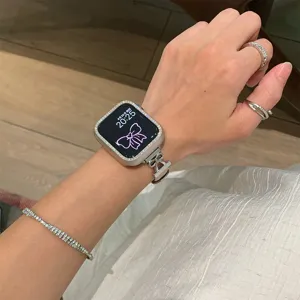 Close-up detail of luxury rhinestone watch case and elegant bow metal strap for smartwatch.
