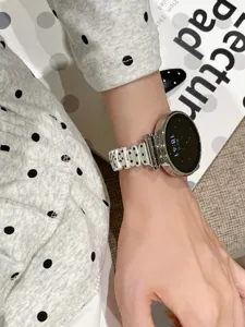 Polka dot irregular metal watch strap compatible with Apple Watch, stylish wrist accessory.