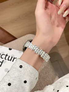 Replacement watch strap for Apple Watch with white links and blue crystal stones.