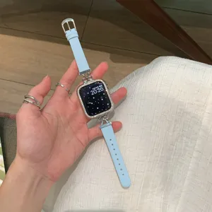 Close-up detail of light blue leather watch strap with rhinestone bow connectors for smartwatches.
