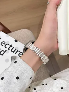 Close-up detail of the stylish irregular beaded watch strap with delicate pink crystal accents.