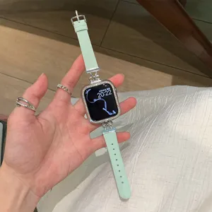 Green leather watch band compatible with apple watch featuring rhinestone case detail.