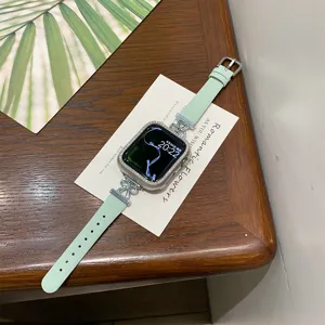 Mint green leather watch strap with rhinestone case and bow connector for Apple Watch detail view.