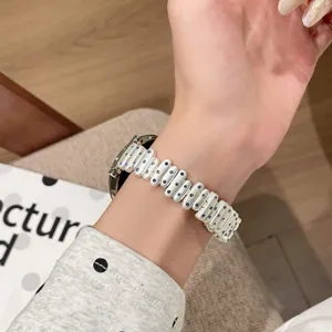 Metal replacement watch band compatible with Apple Watch, chic white studded strap design.