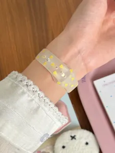 Detailed close-up shot of a frosted TPU smartwatch band featuring cute yellow heart patterns.