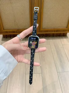 Detail view of a black leather star-patterned Apple Watch band with a metallic silver buckle.