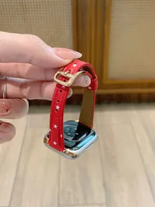 Red leather star watch strap compatible with smart watches, stylish replacement band with buckle.