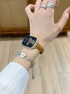 Brown leather star pattern watch band compatible with smart watch, stylish wrist accessory.