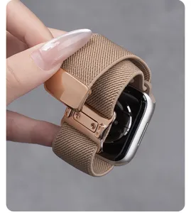 Close-up van khaki geweven nylon horlogeband met roségouden magnetische metalen gesp.