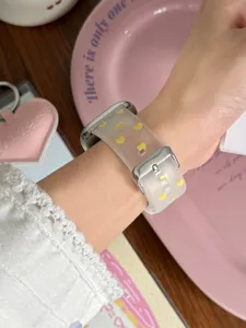 Silicone clear matte watch strap with cute yellow hearts detail worn on wrist elegantly