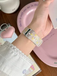 Close-up of translucent matte TPU watch strap featuring cute yellow hearts and silver metal buckle.