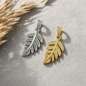 Exquisite leaf pendant necklace with shimmering zircon stones in gold and silver finishes.