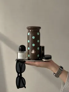 Compact mini thermos flask for women, stylish brown polka dot portable pocket water cup detail.