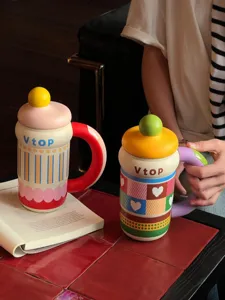 Detailed view of creative ceramic mug with large handle and colorful heart patterns for home.