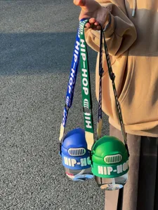 Close-up detail of colorful large capacity plastic water bottles with hip-hop straps for outdoor.