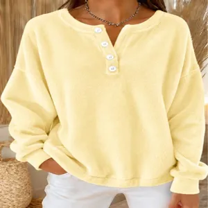Detailed view of the yellow fleece henley sweatshirt featuring white buttons and cozy fabric.
