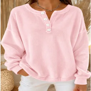 Detail view of women casual loose fleece pullover sweatshirt with henley neck and buttons.
