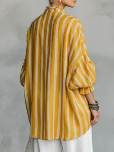 Detail view of the vintage vertical striped blouse with stand collar and lantern sleeves.