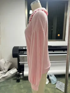 Pink ribbed long sleeve knit sweater for women featuring a chic ruffled collar detail.