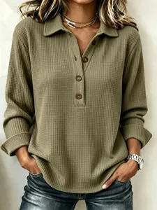Detail view of the casual waffle knit long sleeve top showing texture, lapel and buttons.