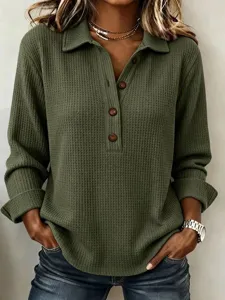 Detailed view of women's casual waffle knit long sleeve polo shirt with buttons in green.