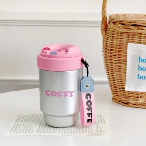 Stainless steel coffee thermos cup with pink lid and strap for daily commuting portable use.