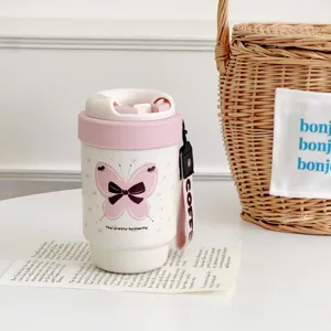 Pink butterfly insulated coffee mug detail showing cute design and strap for daily use.