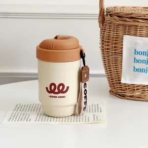 Portable travel coffee mug with lid and strap, ceramic inner liner thermos cup for daily commute.