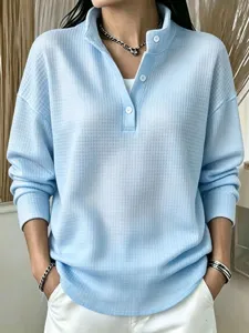 Casual light blue waffle knit long sleeve henley top for women, loose autumn pullover shirt.