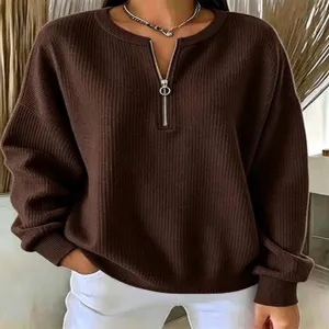 Brown half-zip ribbed knit sweater, loose drop shoulder long sleeve pullover style.