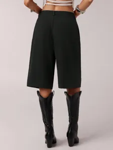 Back view detail of casual black bermuda shorts, high waist design, clean tailored style.