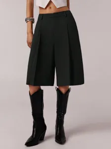 Detailed view of dark grey pleated bermuda shorts, showing tailored fit and smooth fabric quality.
