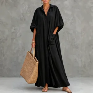 Oversized black long sleeve lapel shirt dress with large pockets and front button closure.