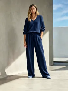 Casual waffle knit two piece lounge set with long sleeve V-neck top and wide leg pants.