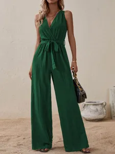 Close-up detail of dark green sleeveless V-neck jumpsuit featuring a high-waisted tie belt.