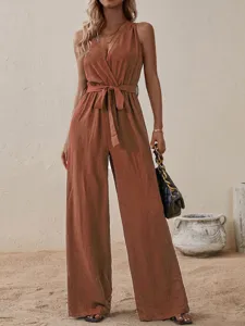 Detailed view of the stylish sleeveless v-neck wide leg jumpsuit with waist tie in rust red.