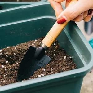 Garden trowel small metal shovel with wooden handle for indoor potted plants and soil loosening.