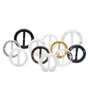 Detailed view of assorted round and floral clothing buckles in various finishes and styles.