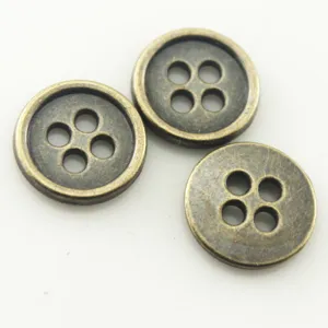 Close-up detail of bronze four-hole metal button, durable retro copper sewing accessories.