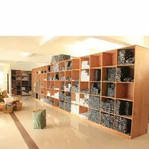 Factory warehouse stock display showing large inventory of metal buttons on shelves.