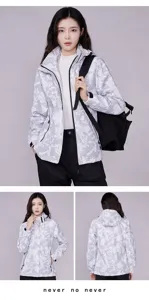 Outdoor camo jacket for women, waterproof hooded windbreaker with geometric pattern.