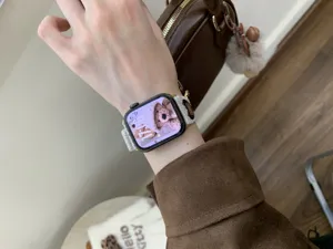 Close-up detail of corduroy watch strap featuring cute bear embroidery for smart watch.