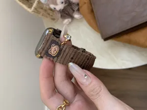 Corduroy Apple Watch band detail, featuring cute bear patch and metal star charm.