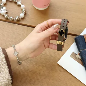 Detailed view of luxury four leaf clover leather watch strap, elegant design for smart bands.