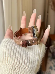 Detailed shot of brown plaid smartwatch strap with cute plush bear charm and leather lining.