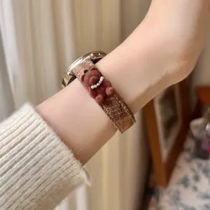 Brown plaid watch strap with cute 3D teddy bear and pearls, compatible with smart watches.