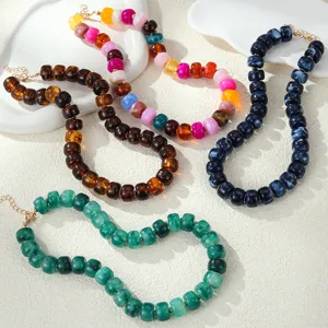 Detailed close-up of colorful acrylic resin bead necklaces, bohemian beach style.